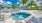 Large sparkling swimming pool with pool deck and cabanas